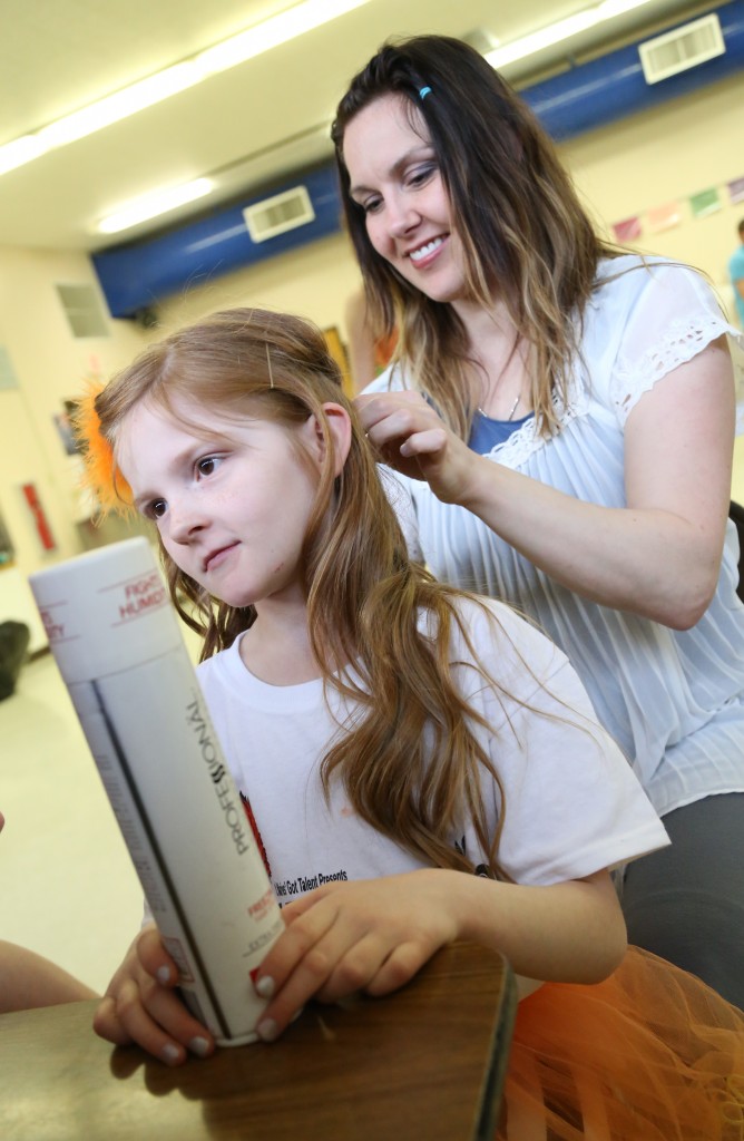 Tara Truscott curls her daughter Addison's hair before the performance.
